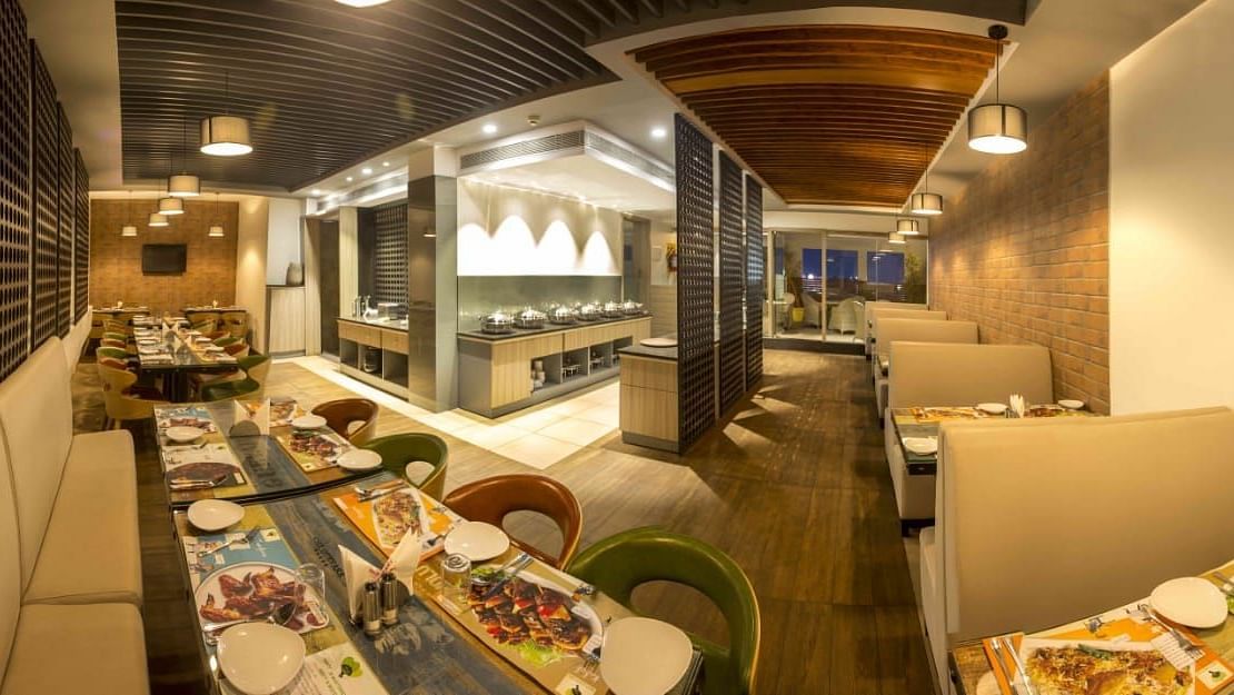 Mint N Mustard Restaurant at Mayberry Tiruppur showcasing a well-arranged dining area with modern decor and comfortable seating
